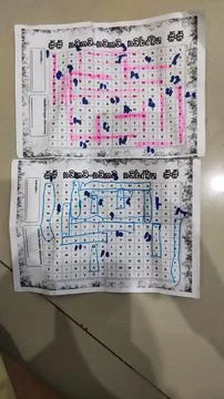 Two printed game sheets with marked paths in pink and blue colors. Stock Photos