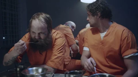 Two prisoners eating at the canteen Stock Footage 283079708