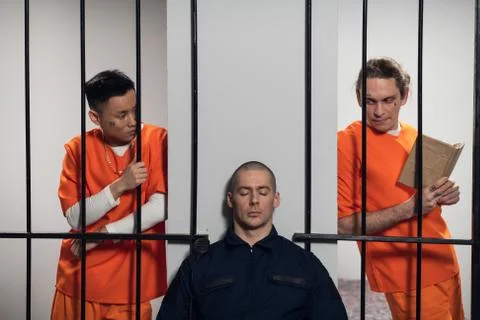Two prisoners plan to attack a uniformed guard to escape from a maximum security Stock Photos
