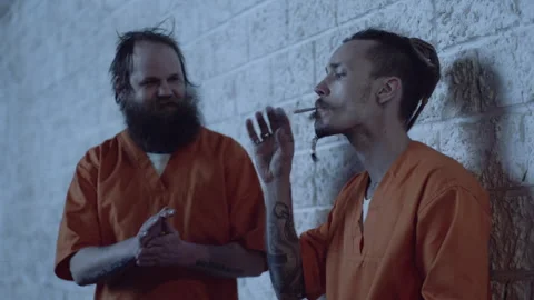 Two prisoners smoking and talking Stock Footage 283081688