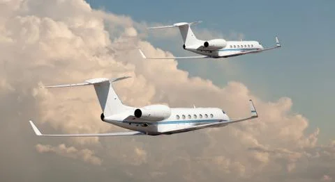 Two private jets flying side by side Stock Photos