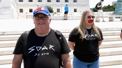 Two Pro-Life Abortion Protesters wearing Tape that says Life Stock Footage 91715016