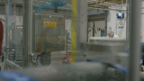 Two production workers examining bottles on production line in factory Stock Footage 107950927