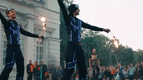 Two professional actors of the fire show perform a trick with fire. Stock Footage 160779611