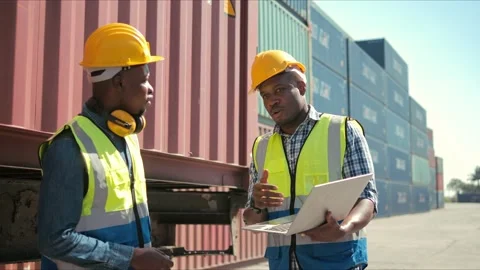 Two professional african engineers wearing safety uniform and hard hats Stock Footage 167580033