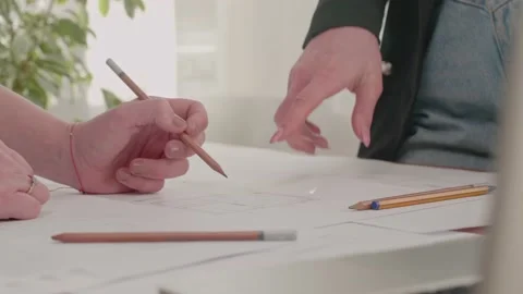 Two professional architects go over blueprints Stock Footage 130881653