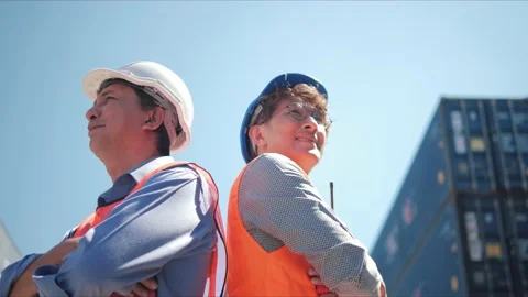 Two professional asian engineer in protective helmet crossing arms Stock Footage 166992193