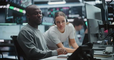 Two Professional Brokers Analyzing Big Data Trends on Multi Monitor Dashboard Stock Footage 330585309