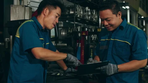Two professional car mechanic using paperwork makes the oil. Stock Footage 153802376