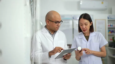 Two Professional confident Pharmacist in checking stock inventory in medical. Stock Footage 249722316