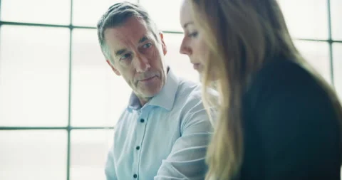 Two professional designers go over blueprints in modern industrial office during Stock Footage 199459076