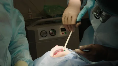 Two professional doctors perform dental surgery Stock Footage 236049799