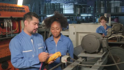 Two professional engineers inspect machines' electric systems at the factory. Stock-Footage 202057335