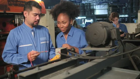 Two professional engineers inspect machines' electric systems at the factory. Stock-Footage 203864153