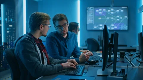 Two Professional IT Programers Discussing Technical Data Show on Desktop PC Stock Footage 103276381