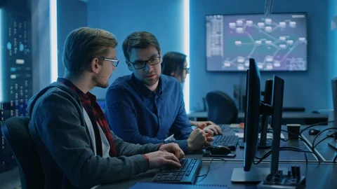 Two Professional IT Programers Discussing Technical Data Show on Desktop PC Stock Footage 103276454