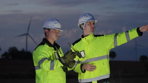 Two professional male engineers in safety uniforms Stock Footage 325560587