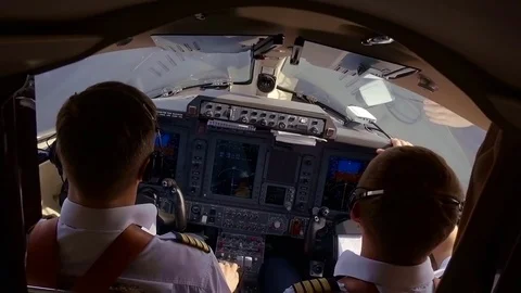 Two professional pilots are flying a jet fighter in sunny day, cabin view from Stock Footage 95162650