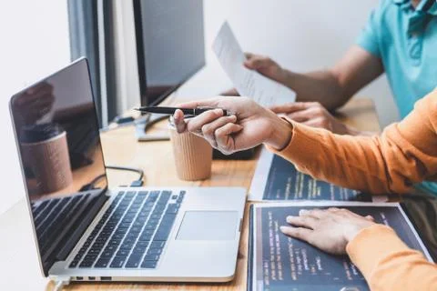 Two professional programmer cooperating and working on web site project in a Stockfoto's