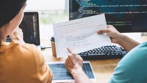 Two professional programmer cooperating and working on web site project in a Stockfoto's