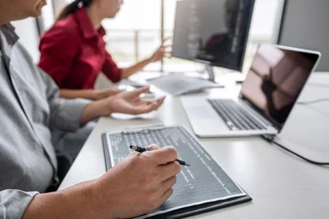 Two professional programmer cooperating and working on web site project in a Stock-Fotos