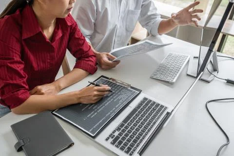 Two professional programmer cooperating and working on web site project in a Stock-Fotos