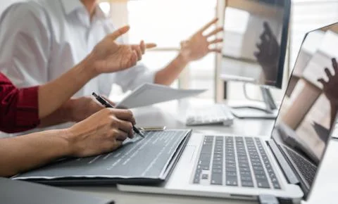 Two professional programmer cooperating and working on web site project in a Stockfoto's