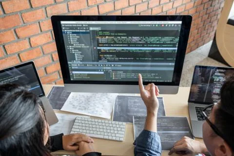 Two professional programmer cooperating and working on web site project in a Stock-Fotos