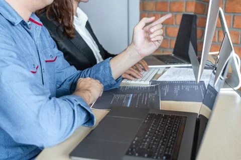 Two professional programmer cooperating and working on web site project in a Stockfoto's