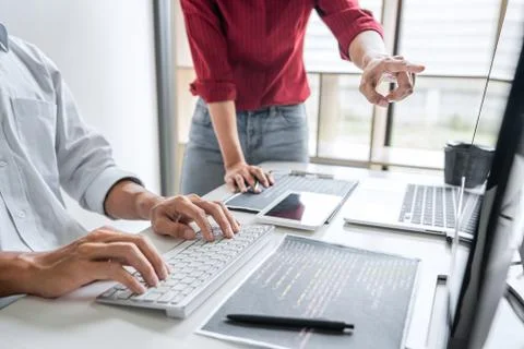 Two professional programmer cooperating and working on web site project in a Stock-Fotos