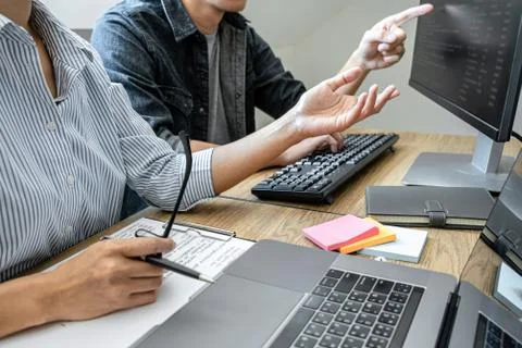 Two professional programmer cooperating and working on web site project in a Stock-Fotos