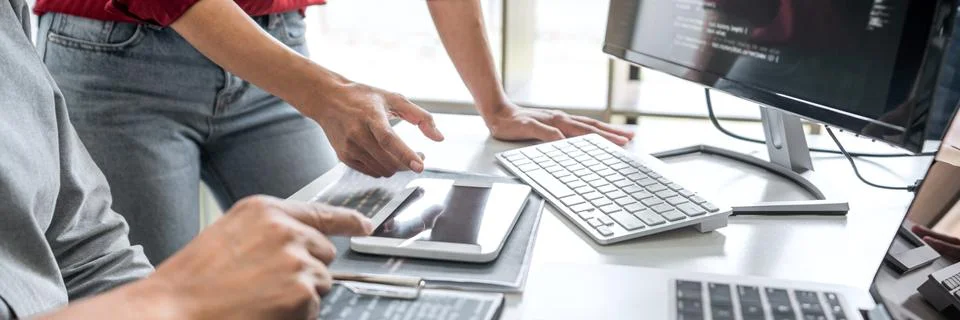 Two professional programmer cooperating and working on web site project in a Stock-Fotos