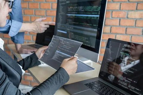 Two professional programmer cooperating and working on web site project in a Stockfoto's