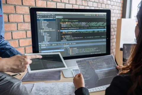 Two professional programmer cooperating and working on web site project in a Stock-Fotos