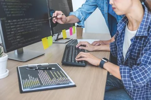 Two professional programmers cooperating at Developing programming and websit 库存照片