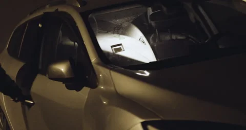 Two professional surfers getting in car on parking lot and talking at night Stock Footage 160572062