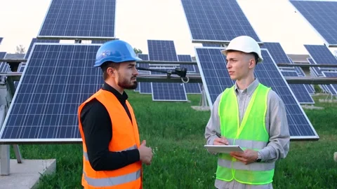 Two professional white engineers discuss the plan to install the new solar Stock Footage 151720721