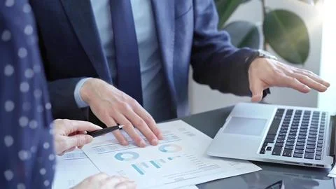 Two professionals analyzing a pie chart during a strategic business meeting 스톡 사진
