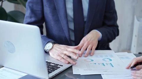 Two professionals analyzing a pie chart during a strategic business meeting Stock-Fotos