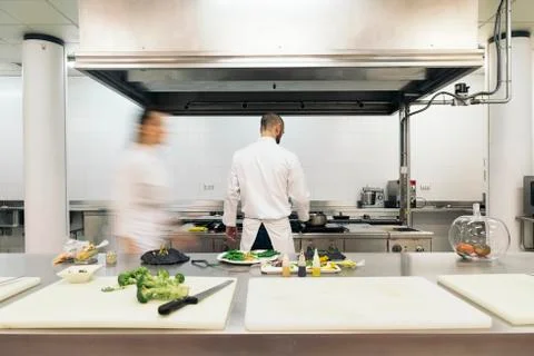 Two professionals chefs cooking together. Stock Photos