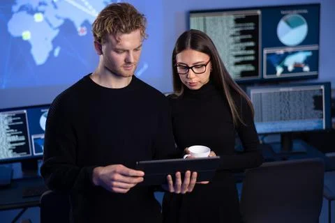 Two professionals in cyber security team working to prevent security threats Stock Photos