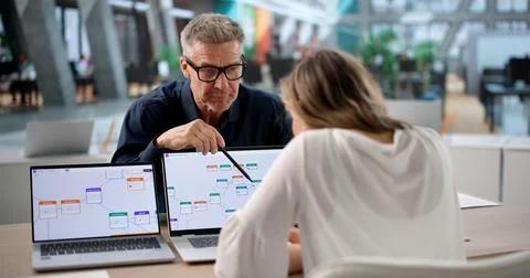 Two Professionals Discuss Software Automation And Workflow Optimization Proje Stock Photos