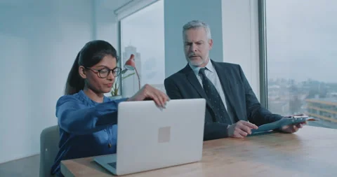 Two professionals discussing project in the office Stock Footage 208040516