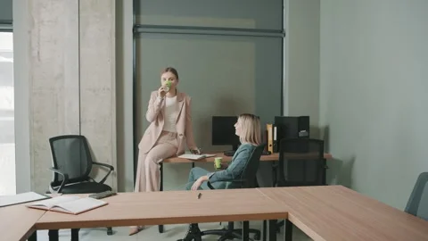 Two professionals engage in a discussion within a stylish office Stock Footage 310557005
