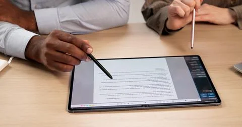 Two Professionals Review Important Contract Papers, Negotiating Terms And Str Stock Photos