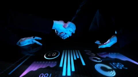 Two professionals shaking hands over futuristic touch screen with digital Stock Photos
