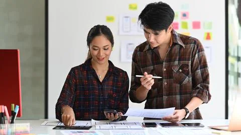 Two professionals web developers are working on software development and using Stock Photos