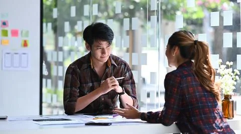 Two professionals web developers brainstorming and working together for mobile Stock Photos