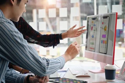 Two professionals web developers working together for mobile application Stock Photos