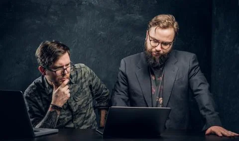 Two programmers are thinking hard, trying to find a solution to the problem in Stock Photos